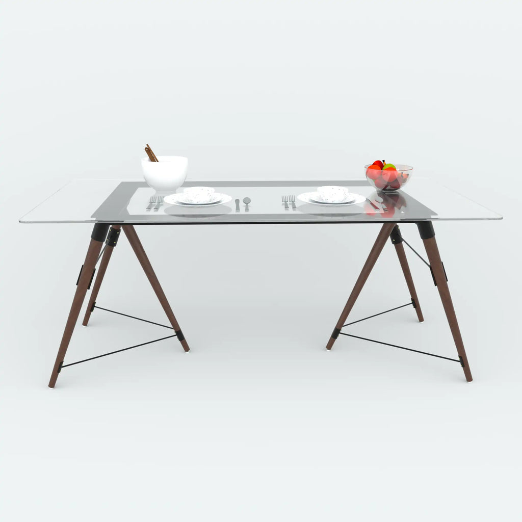 Fexon dining table with a clear top and angled brown legs, viewed along the long side.