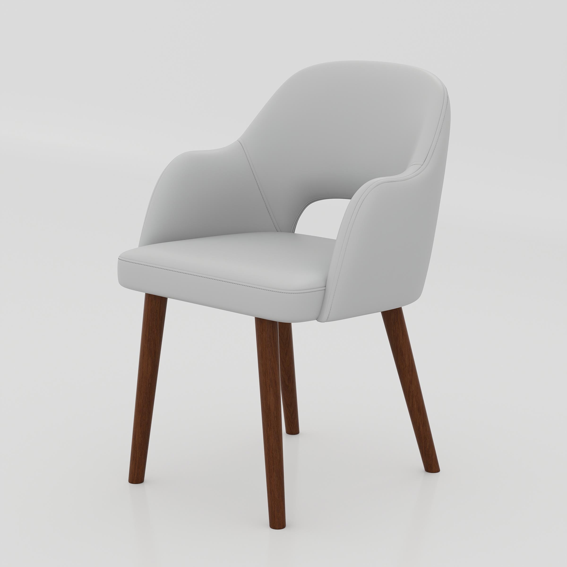 The Ravel Dining Chair brings comfort and style together with its soft foam seating, smooth Rexine finish, curved back support, and warm wooden-leg design.