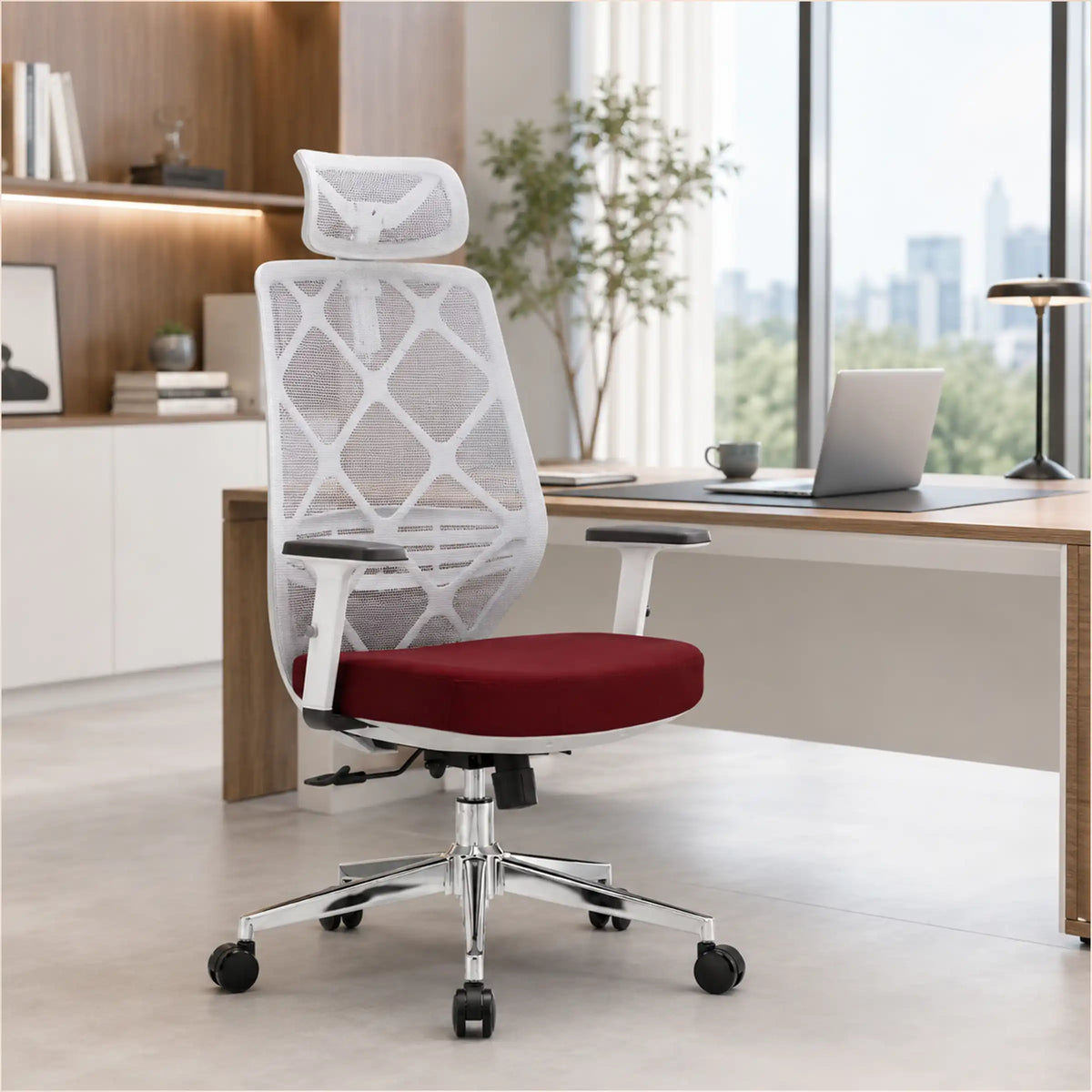 A modern mesh office chair with a white geometric backrest, red cushioned seat, and chrome five-star base, positioned in front of a wooden desk in a bright, contemporary home office.